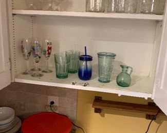 Kitchen cupboards, containing an assortment of glassware
