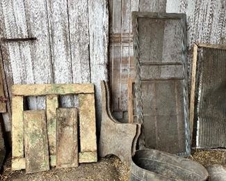 Small old paneled door, copper boiler,  old window screens, wooden bench ends