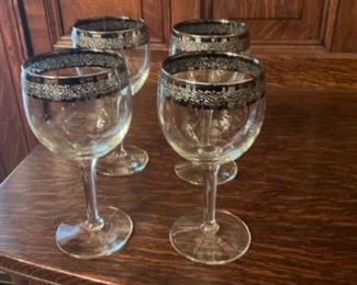 Silver rimmed wine glasses. Selling in sets of four.