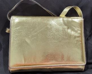 Purse 16 Salvadore Ferragamo gold soft handbag clutch.  Very nice gently used bag.   Clean inside and out.  Minimal wear to the outside.  Strap can be removed to make a cute gold clutch. 
8 X 6 