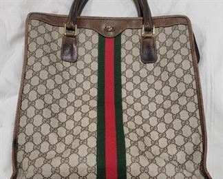 Purse 20 Gucci tote in good used condition.  Stitching looks fine.  Some wear to edges and stain to bottom of the inside.  16 X 14 