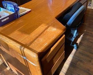 Teak desk 6' long x 36 1/2" deep at the deepest place, one file drawer on right and 3 drawers on left