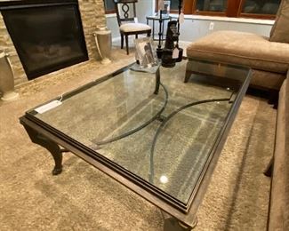 Iron with thick beveled glass top coffee/cocktail table. 54 inches long, 36 inches wide, 19 1/2 inches height, glass is 1/2 inch thick.