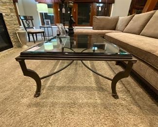 Iron with thick beveled glass top coffee/cocktail table. 54 inches long, 36 inches wide, 19 1/2 inches height, glass is 1/2 inch thick.