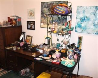 Desk, file cabinet, office supplies and decorative items.