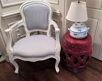 French fauteuil painted white with gray upholstery; red garden seat