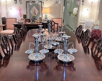 Stunning mahogany dining room table with display of sterling center epergne and (4) silver plated epergnes