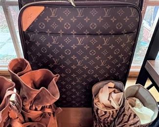 Louis Vuitton rolling carry-on with cover.  And…those boots!