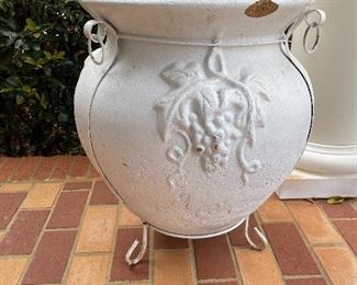 Large clay pot in metal stand