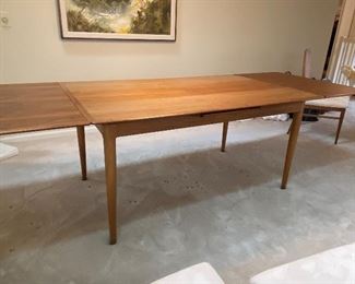 Mid Century Danish Skovmand & Andersen Teak Draw Leaf Dining Table, c.1960s.  Comes with 6 cane and upholstered chairs, 2 arm chairs, 4 armless. Both leaves slide underneath converting the table to a smaller size. Approx. size with both leaves: 8'6l x 3'1w x 2'4h