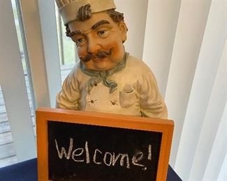 Chef statue with chalkboard sign