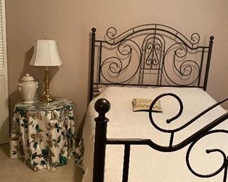 Full bed and lovely bedding with dust ruffles, table, pillows and window treatment