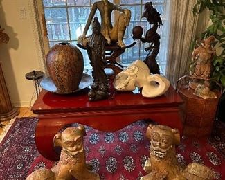  A large high quality Asian inspired red lacquer coffee table as well as many Asian inspired decorative pieces.