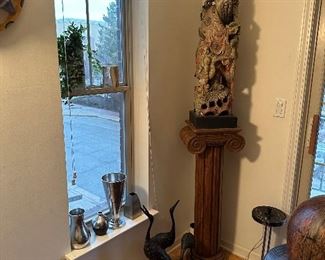 Antique wood column and a large carved wood Asian sculpture.