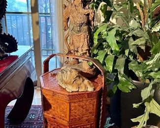Carved wood Chinese man on top of a bamboo Chinese tea box.