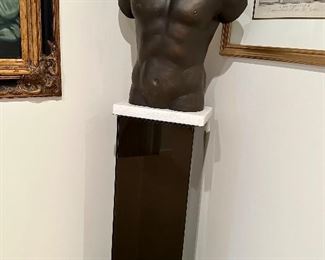 Metal torso on square acrylic display stand.