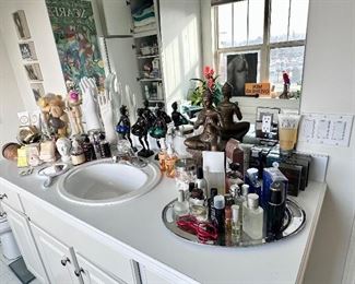 Bathroom full of decor, colognes & care items.