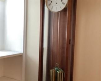 Howard Miller clock with Westminster chime.  Measures 41” h x 7” d x 11” w. 