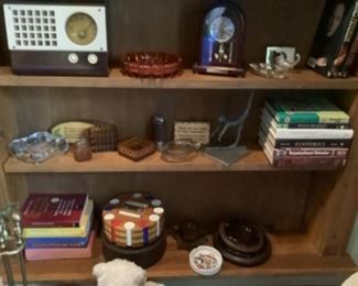 Old radio, vintage ashtrays, older poker chip holder, books, clock, etc