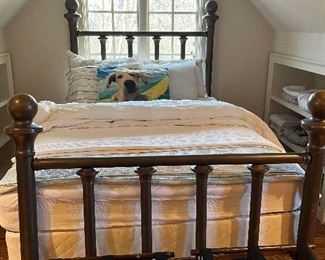 Vintage full sized Brass Bed with wooden wheels.  