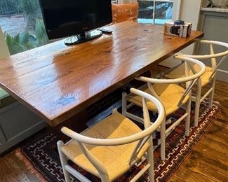 Solid wood kitchen table, accompanied by these adorable wicker seat, round back chairs.