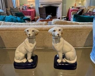 Ceramic white dog statuettes.