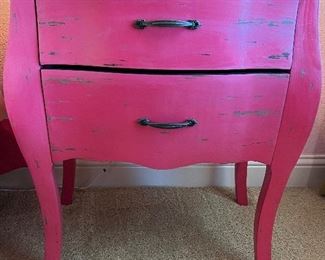 There are two of these cute, hot pink nightstands