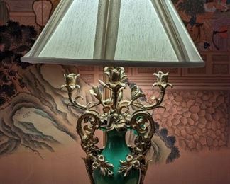 This house was custom built by the owners and very little overhead lighting was used. The owner loved good table lamps, chandeliers, sconces, etc, as the large living spaces needed more intimate lighting than the typical overhead or track lighting of the era. This lamp is exemplary of her taste for unusual and one-of-a-kind lighting. This dude is an amazing antique French table lamp, w/ornate brass ormolu and green porcelain base, w/Waterford silk shade.