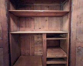 Interior shot of the antique French armoire, which has been painstakingly fitted for electronics.