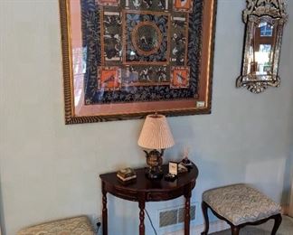 One of two nicely framed Hermes scarves, small Asian brass table lamp, pair of French oak stools, mahogany demilune table and Venetian wall mirror.