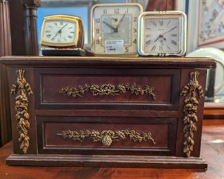 Close-up of the bronze mounts on the drawers of the desk top section, wth beveled glass mirror.