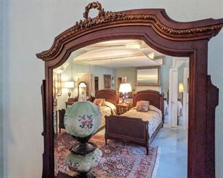 Beautiful detailing of the top of each of the beveled glass mirrors.