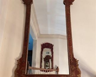 The old "infinity mirror" trick, with a pair of hand-painted, Asian-inspired wooden wall mirrors.