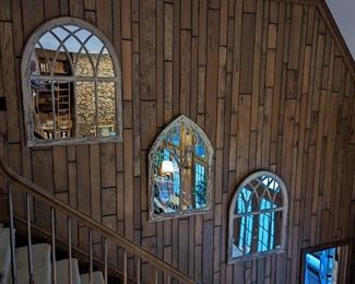 Love the vintage 1970's wooden paneling, but it's rather dark - this trio of "church window" mirrors brightens up this cave house.