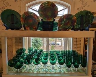 Close-up detail of the five complete sets of vintage Tiffin "Franciscan-Killarney" stemware, produced 1950 - 1966, as well as three 19th century Wedgwood seashell majolica plates, in mottled tortoiseshell finish.