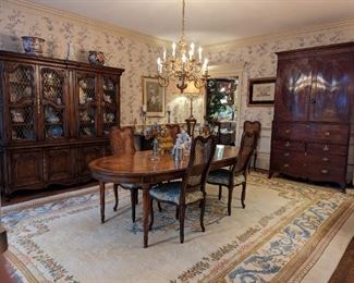 Ahh, STRAIGHT outta Architectural Digest, 1973! An entire dining room suite of vintage pecan, French provincial Karges Furniture (Evansville, IN) including 4-door china cabinet, with glass/metal fronts, bar cart on casters, dining table with three leaves, set of eight chairs (2 arms, 6 sides) antiqued blue wooden hutch, with chicken wire doors and a matching bachelors chest, all atop a vintage Chinese 90-line, hand-woven Aubusson wool rug, measuring 11' x 17'.