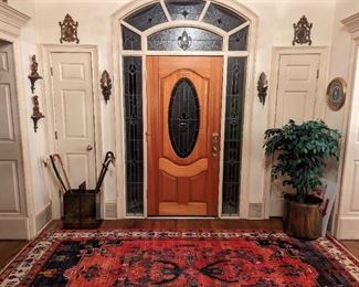 Foyer of the yummy house, with vintage brass Sarreid Ltd. umbrella stand, silk ficus in brass planter, antique brass picture frames, pair of custom made sconces flanking the front door and vintage Borghese figurines on sconces.