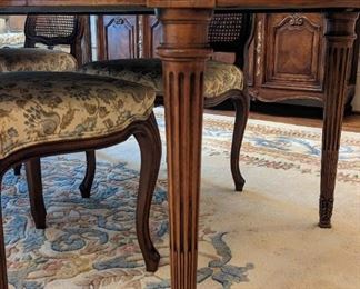 Fluted leg detail of the vintage French provincial dining table.