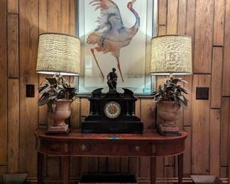 Beautifully inlaid/burled mahogany "Copley Place" console table, by Hekman Furniture Co., Grand Rapids, MI, pair of custom made table lamps, with vintage Italian terra cotta urns and hand-made L-R facing brass floral details (by Paul Smith, ATL lamp genie) one of a pair of nicely framed/matted crane prints, by Carol Griggs, this one is entitled "Bird of Happiness", large black slate Italian mantle clock with bronze figure of Lorenzo de Medici, pair of custom made mirror and poplar bark planters and a pair of flared hand-colored metal planters.