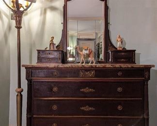 Beautiful 9-drawer chest, with bronze mounts, gorgeous marble top and beveled glass mirror, customized vintage brass/onyx floor lamp, with gold leaf on globe interior, vintage Hummel figure Mary, Joseph and camel.