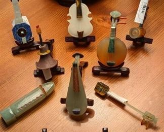 Collection of miniature stone Asian instruments.