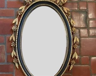 Vintage Parcel Gilt Ebony Oval Ebony Mirror. Measures 44" H x 23" W. 