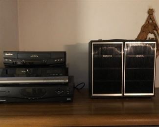(L-R) Quasar VHS Player, Magnavox VHS Player, General Instrumet 4Dtv Satellite Receiver, Sony Tapecorder.