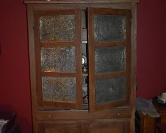 Awesome Primitive Pie Safe in Wonderful Condition! and full of Collectibles and I see an Antique Treadle Sewing Machine just to the right