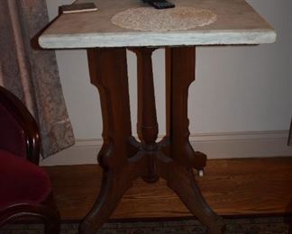 Antique Marble top Table with Victorian Base and white porcelain wheels