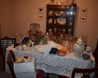 There is a Lovely Mahogany Dining Table and Chairs to match the Hepplewhite Style Cabinet that reside under th Gorgeous Crochet Table Cloth and Collectibles atop the table 