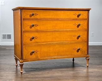 SCHMIEG & KOTZIAN DRESSER  |  Tiger maple, inlaid in contrasting woods, having a concave front with four graduated drawers with wood pulls, fluted columns, on tapering feet - l. 42 x w. 20 x h. 34.5 in.