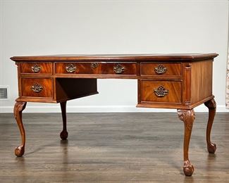 CHIPPENDALE STYLE DESK  |                                                             Beautifully figured wood, having an inset leather top in three sections, five drawers with brass handles, over cabriole legs with ball and claw feet - l. 56 x w. 27 x h. 30 in.