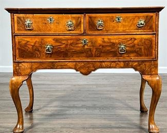 WALNUT VENEERED LOWBOY  |                                                  Having two drawers over a full width drawer, sculpted apron, cabriole legs, with old "Alan M. Roberts, Inc. Antiques" stamp inside drawer - l. 38.25 x w. 22.5 x h. 31.5 in.