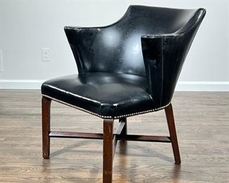 ANTIQUE LIBRARY ARMCHAIR  |                                                  Black vinyl upholstery with scroll arms and brass tacks, on a wood frame base, no apparent maker's mark - l. 29 x w. 27 x h. 31 in.